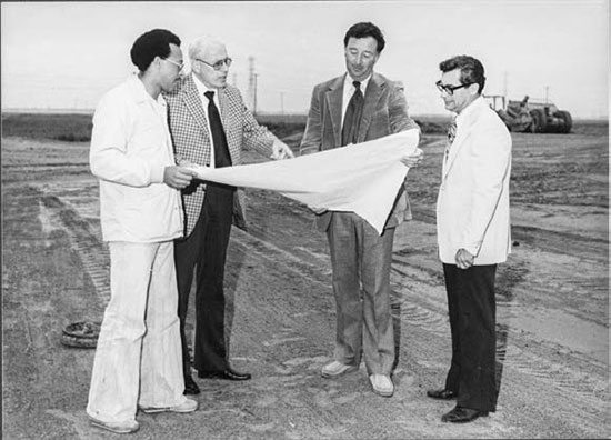 Men reviewing plans for construction of track