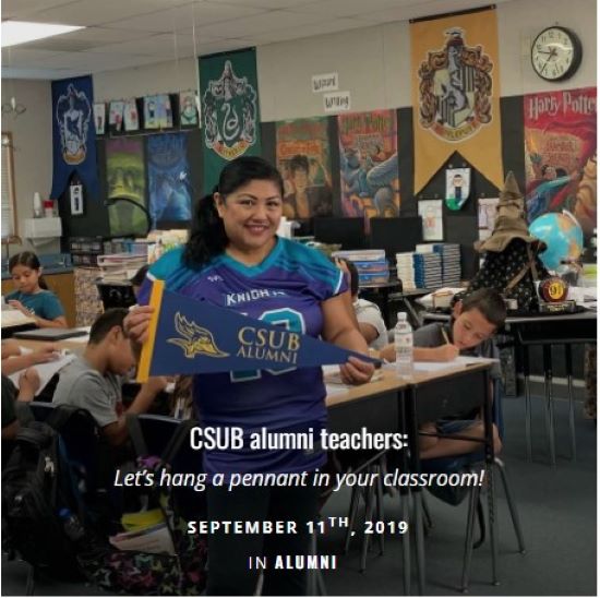Teacher holding a CSUB pennant in her classroom