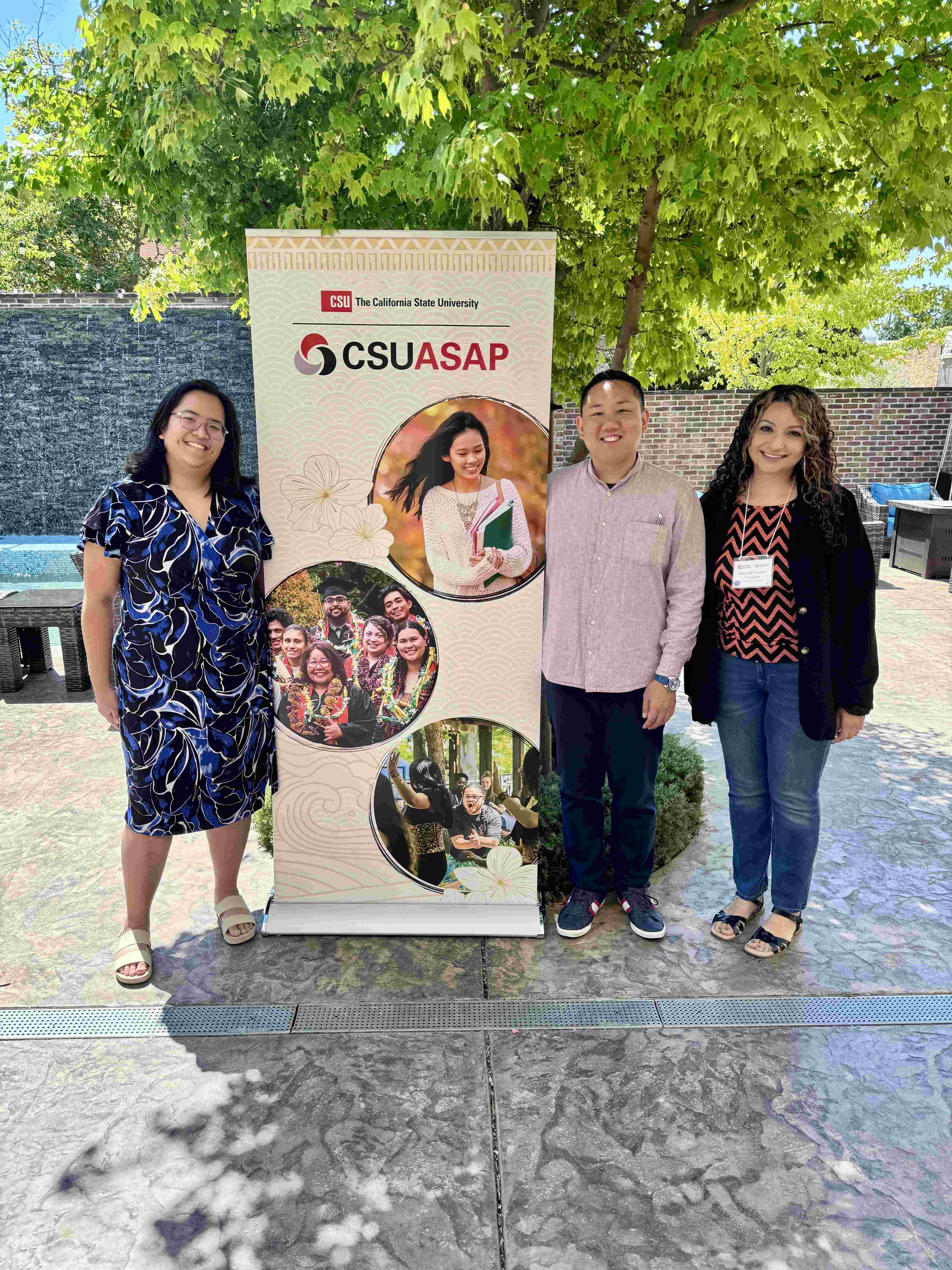 Marrian Angeles, Mike Kwon, and Anayeli Gomez-Navarro standing next to a CSU AANHPI Student Achievement Program (CSUASAP) sign.