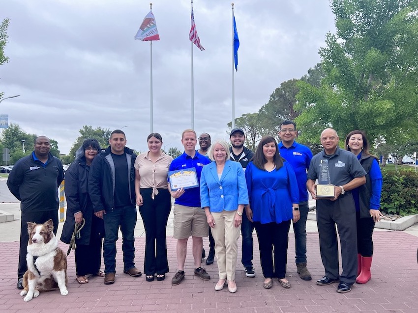 Group photo in front of flag poles