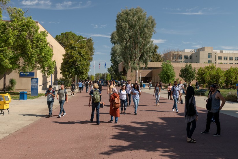 Students walking on CSUB's red brick road