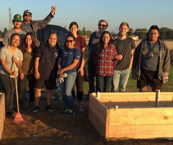 Volunteers building a raised bed at the edible garden