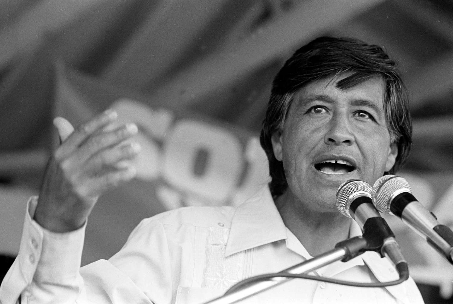 Cesar Chavez speaking into a microphone.