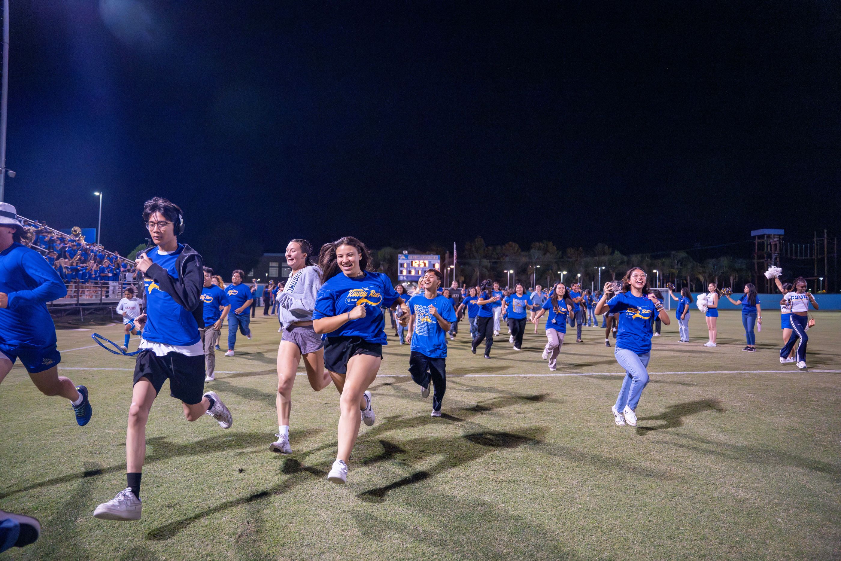 Group of CSUB students running across the field during the 2024 Rowdy Run