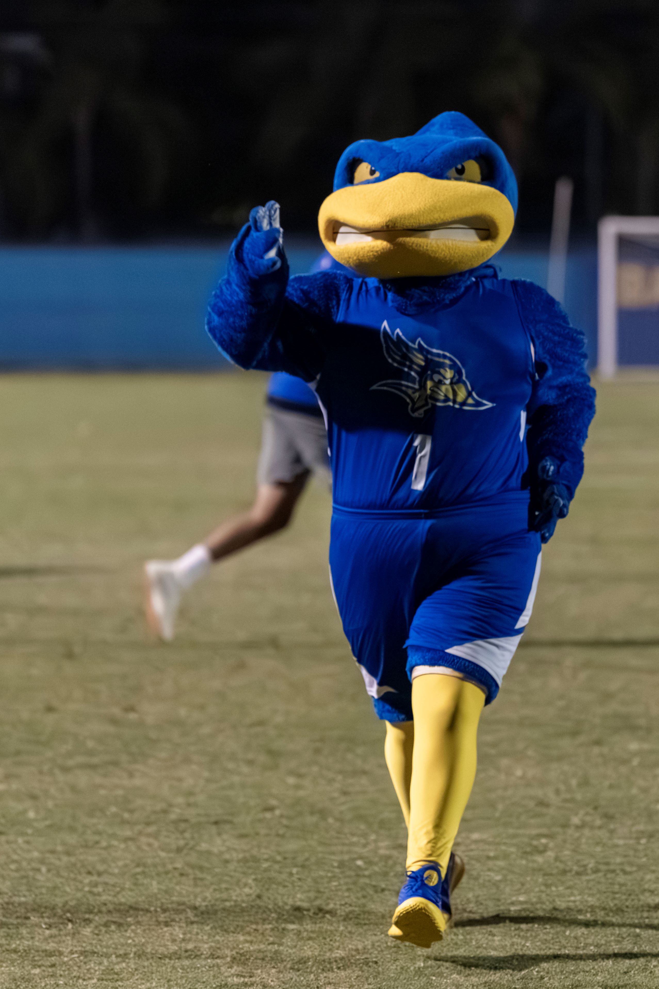 Rowdy Running across the soccer field wearing the blue Rowdy Run 2025 T-shirt.