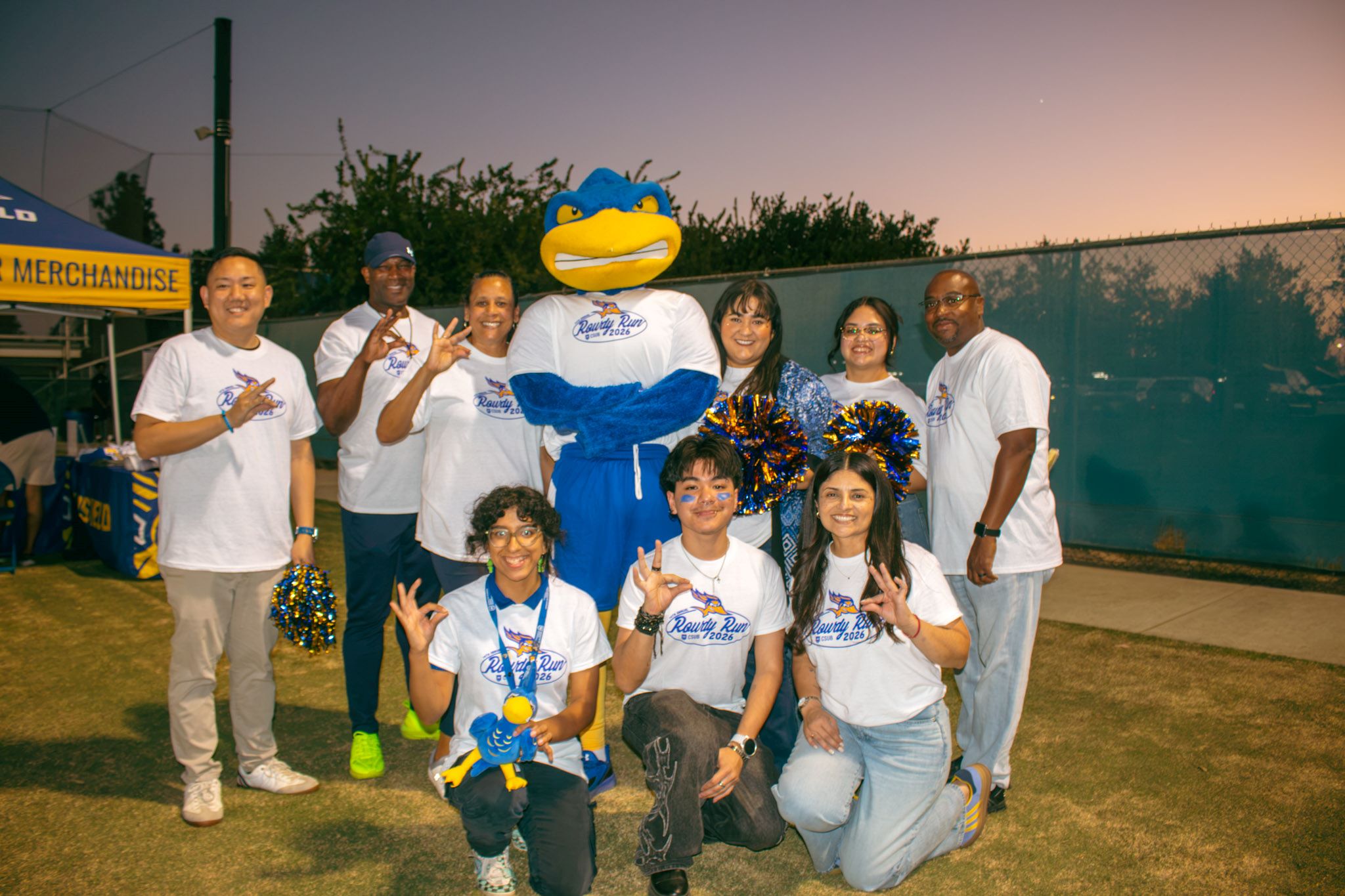CSUB students and staff pose with Rowdy while wearing the white 2026 Rowdy Run T-shirt