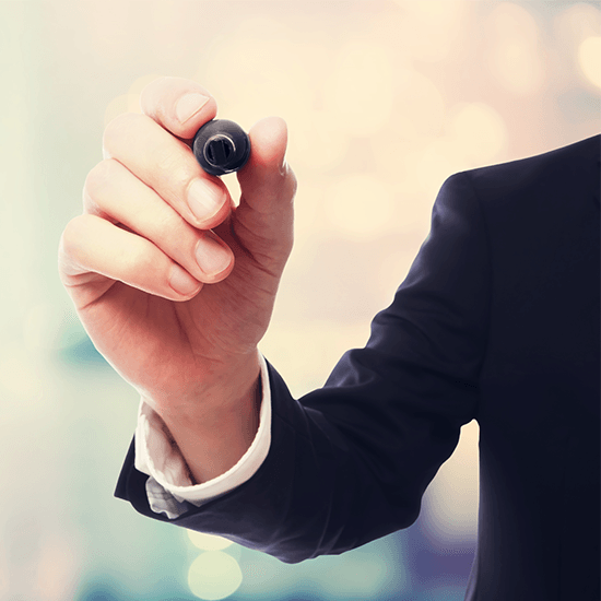 Man wearing suit jacket holding marker