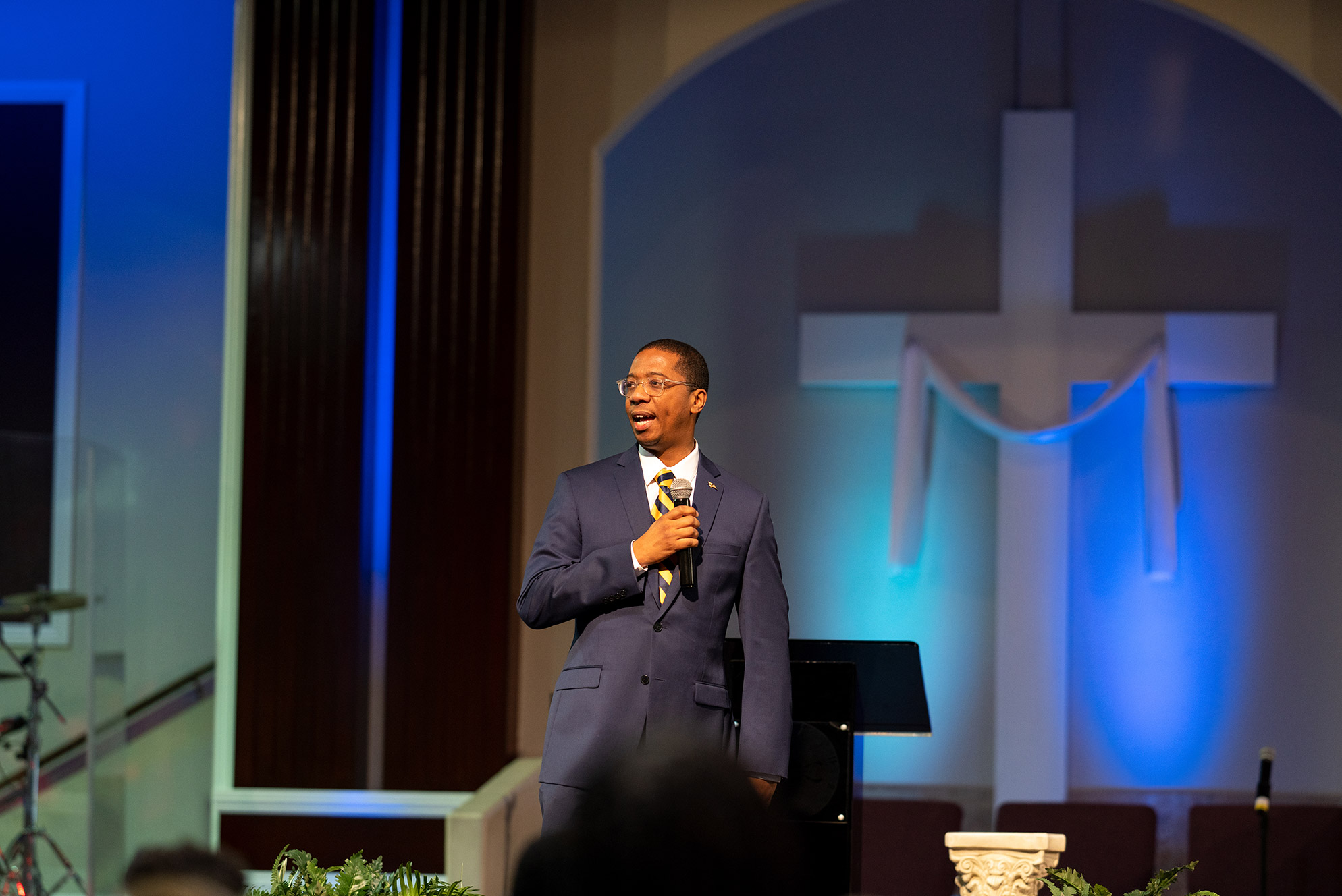 Pastor at church speaking into microphone