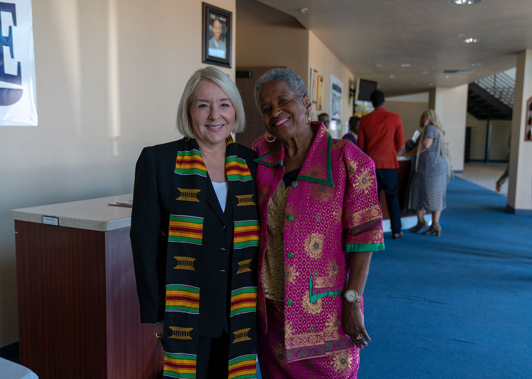 Two women standing next to each other and smiling