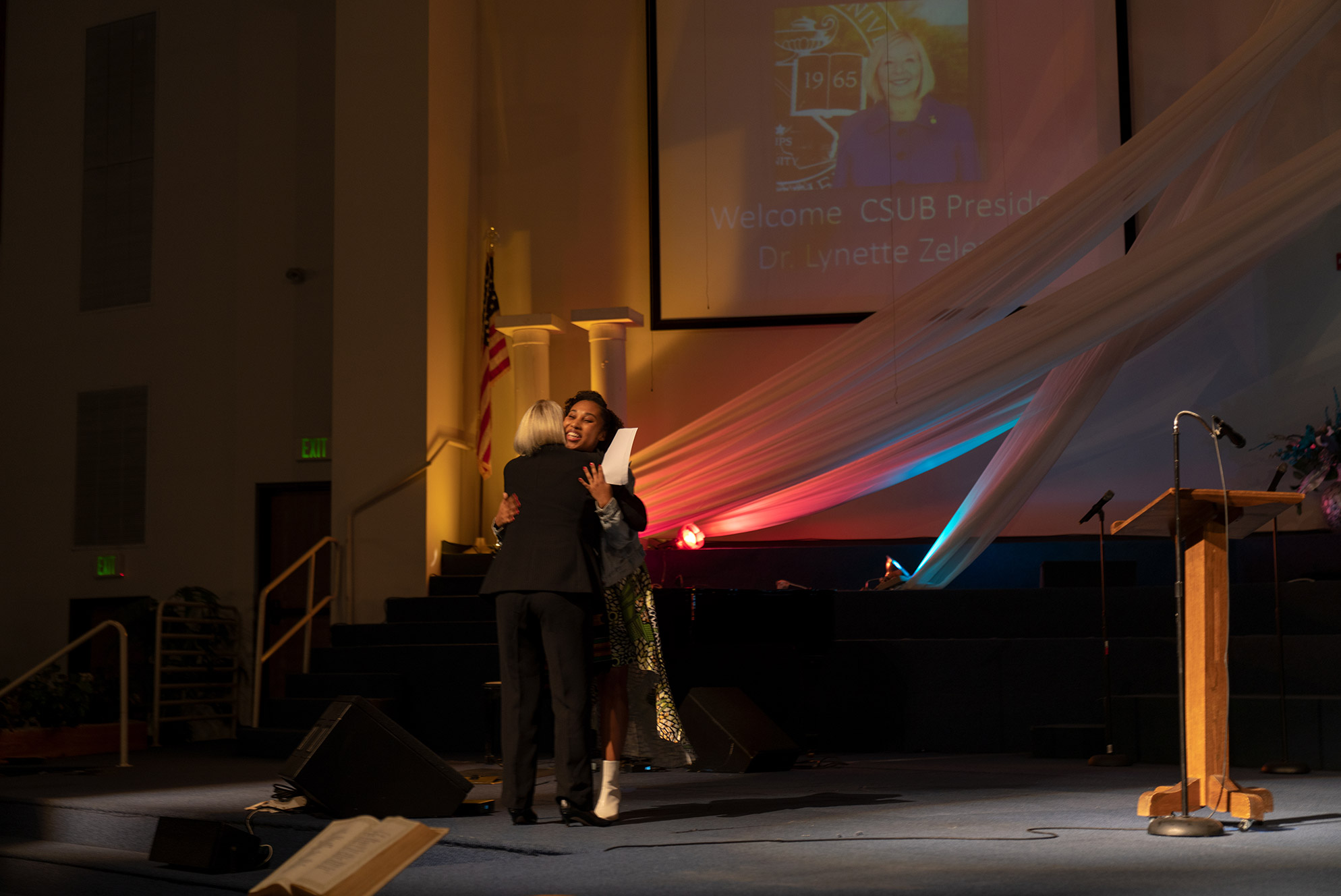Two women hugging each other on stage
