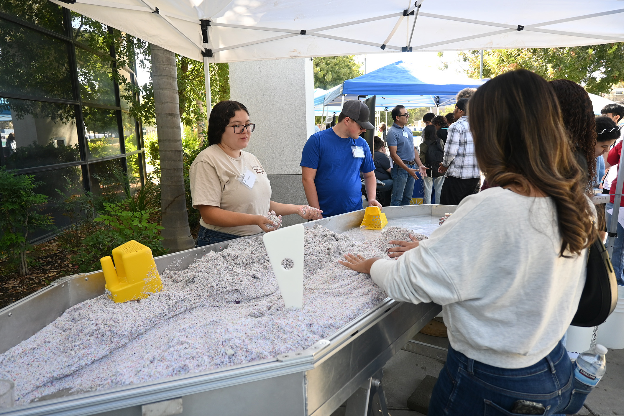 Students Izzy and Jack show visiting students the stream table