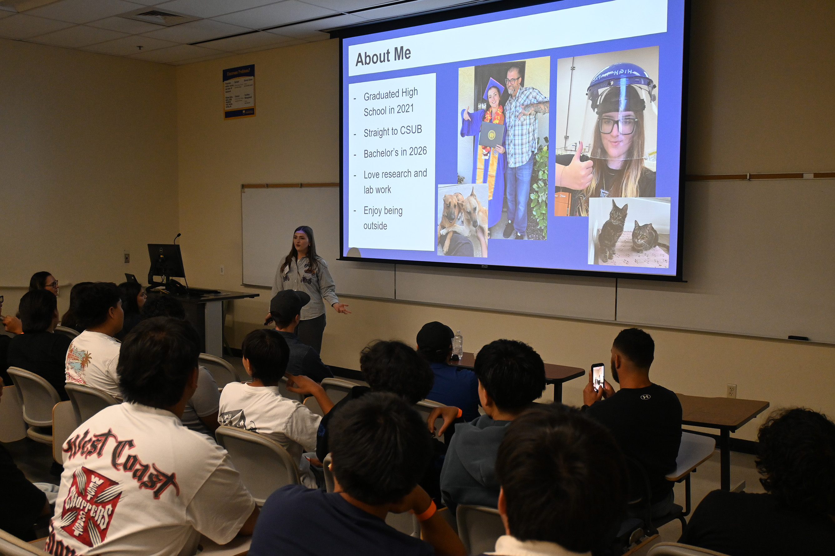 Student Brooklyn talks to the visiting students about her research experiences