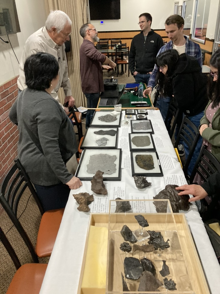 Dr. Crewdson shows off a variety of meteorite samples