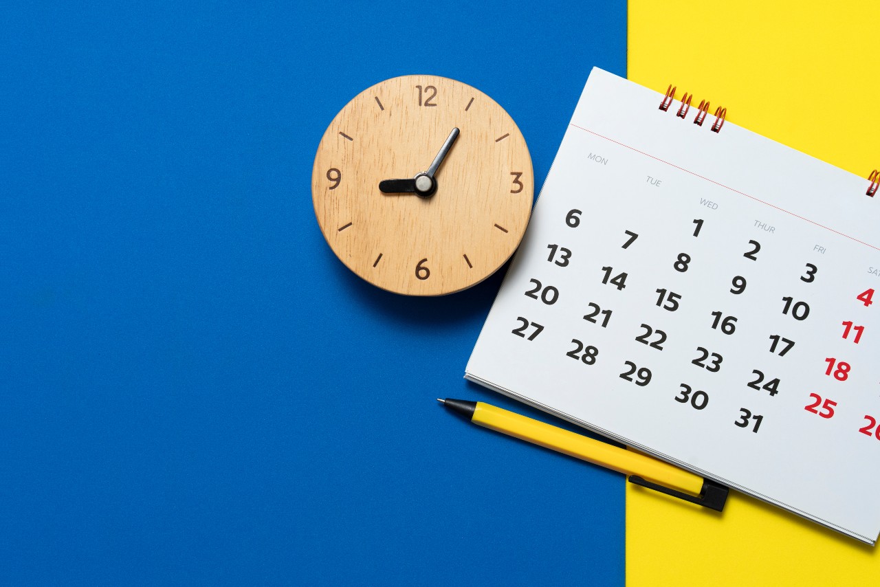 Calendar and clock on blue and yellow background