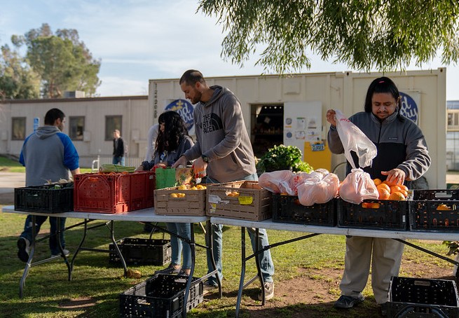 People unloading produce next to the CSUB Food Pantry