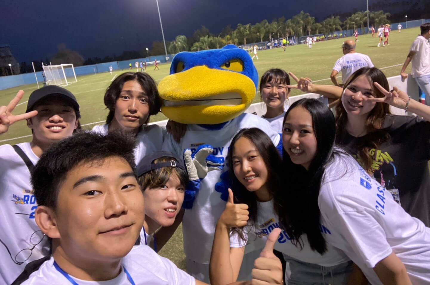 Students in a group photo with school mascot