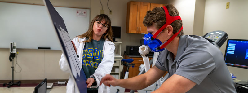 Doctor with patient on exercise bike