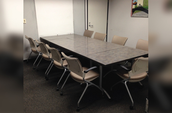 Student Union Green Room with tables and chairs arranged in a conference layout.