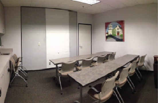 Student Union Green Room with tables and chairs facing forward.