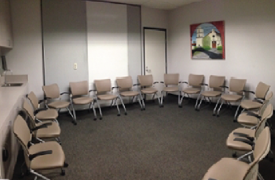 Student Union Green Room with chairs in a circle around the perimeter facing the center.