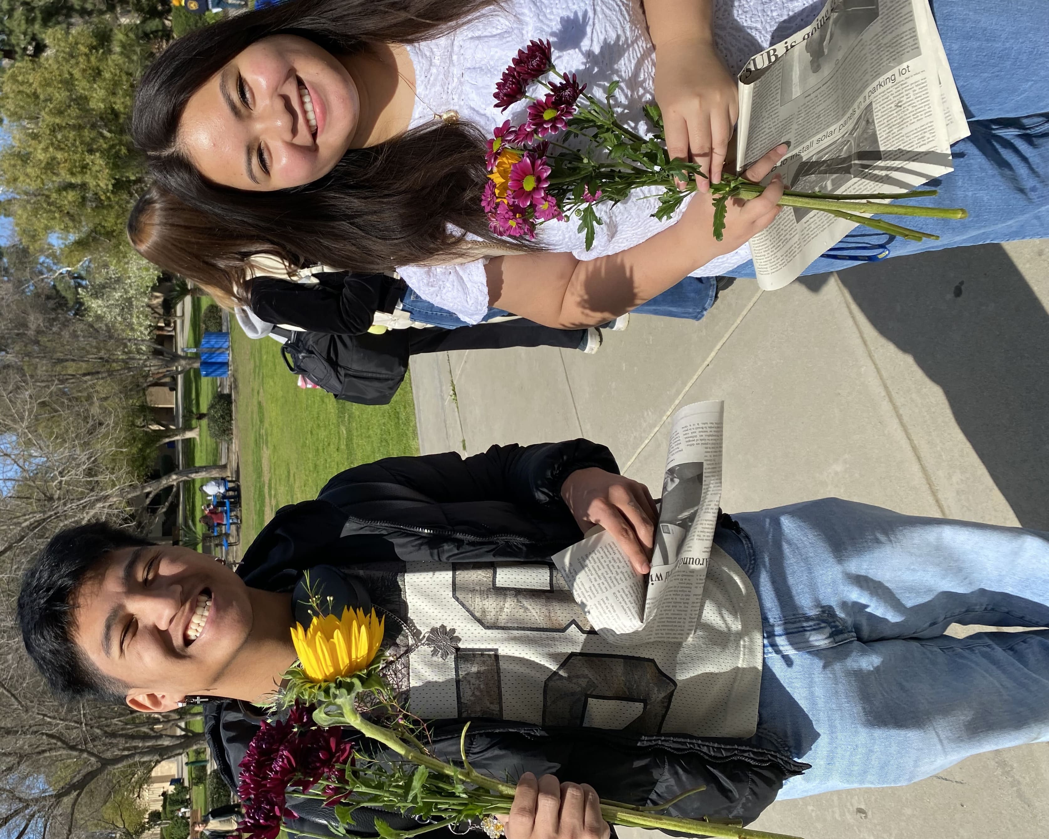 Two people holding flowers