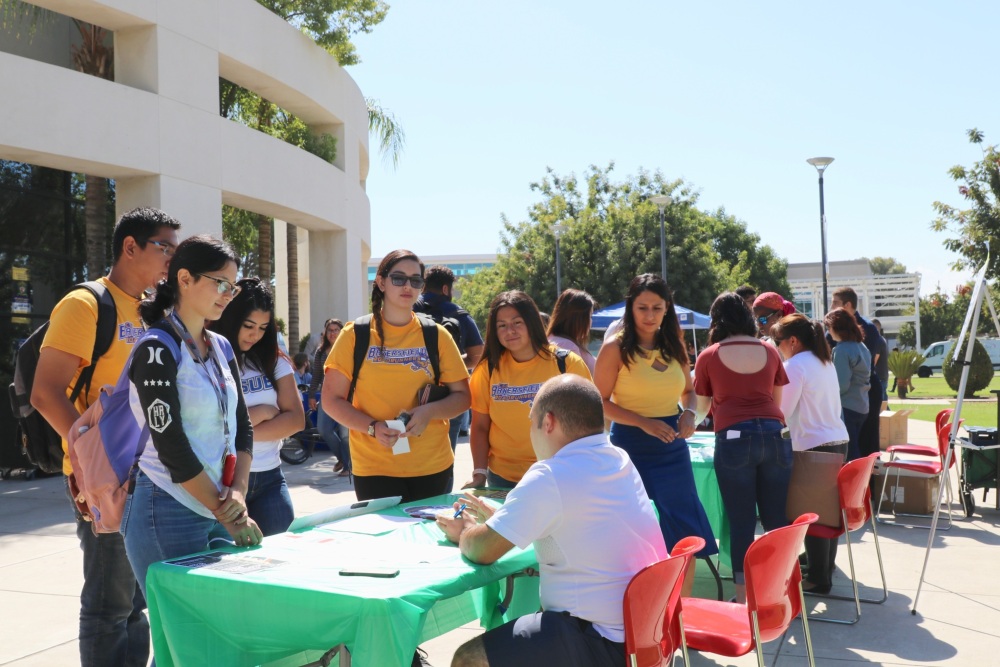 Students at a booth on campus.