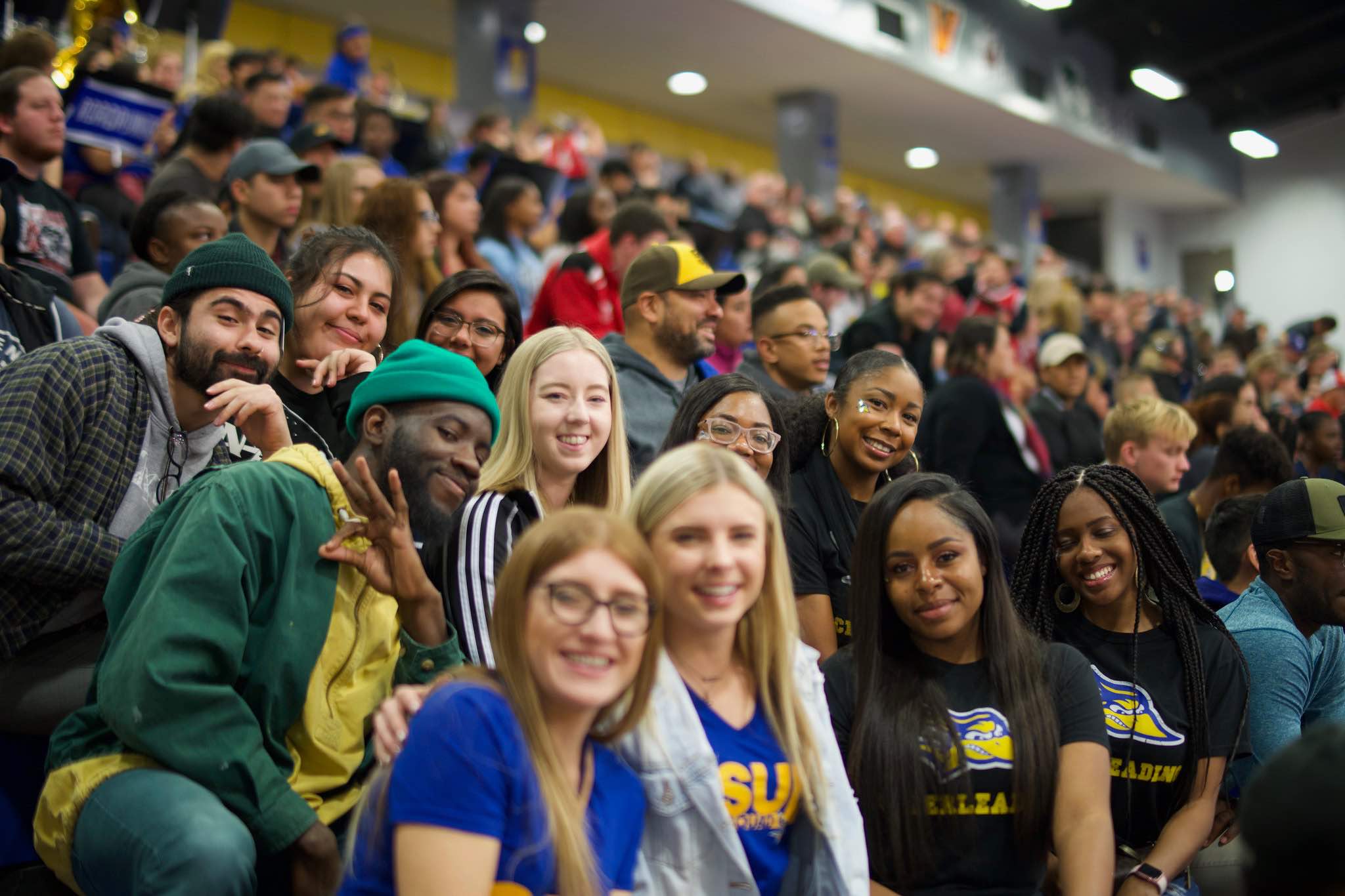 Group of students sitting on bleachers in the Icardo Center