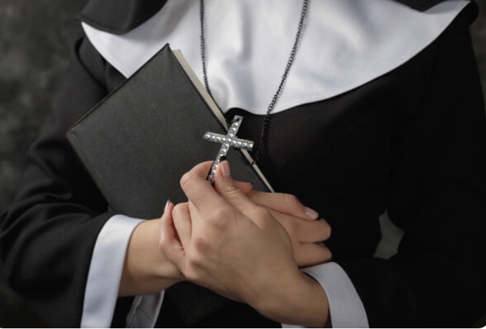 nun holding cross and bible
